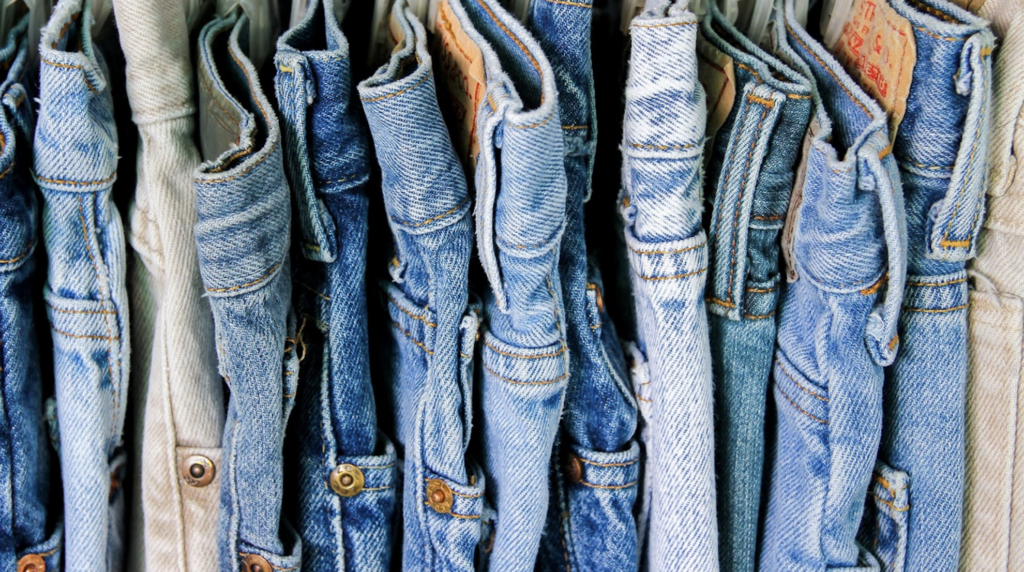 many pairs of denim jeans in a row